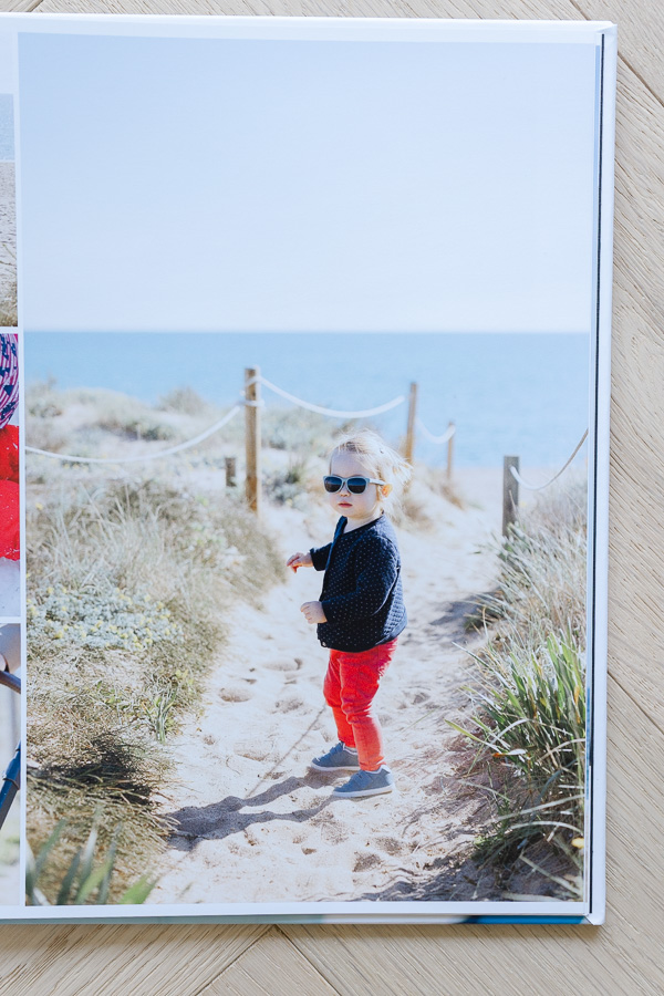 Close up of Floricolor photo album page showing child with sunglasses on beach path