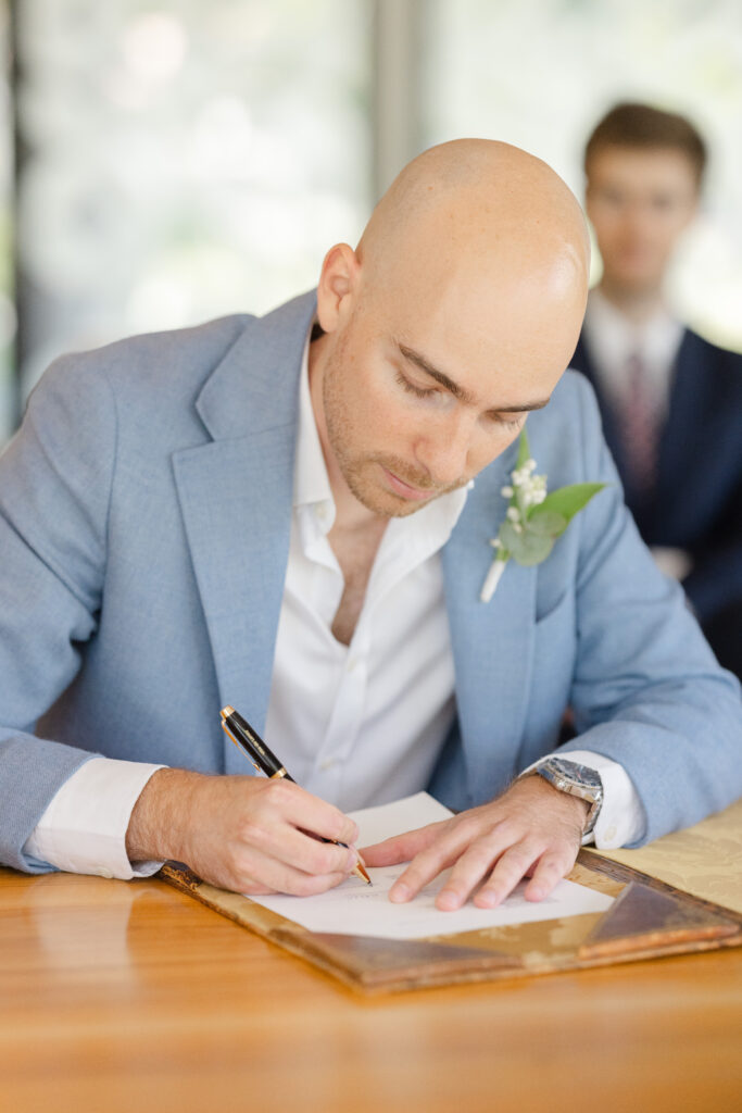 Groom signing the wedding register at Mairie de Lancy Geneva civil wedding
