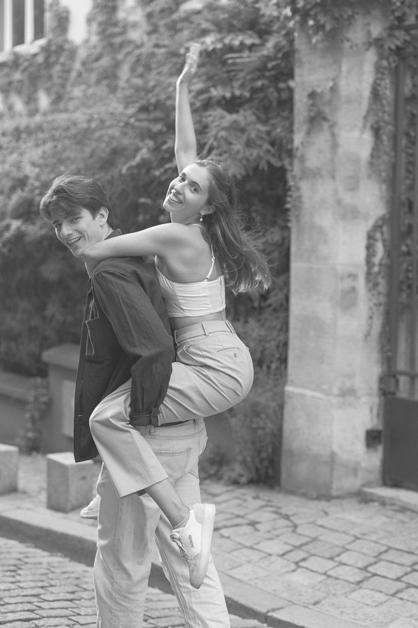 Bride on groom's back laughing during couple photo session in Montmartre Paris