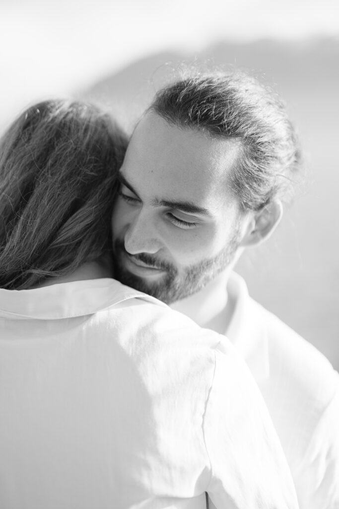 Black and white intimate portrait of couple embracing during engagement session Lavaux Switzerland