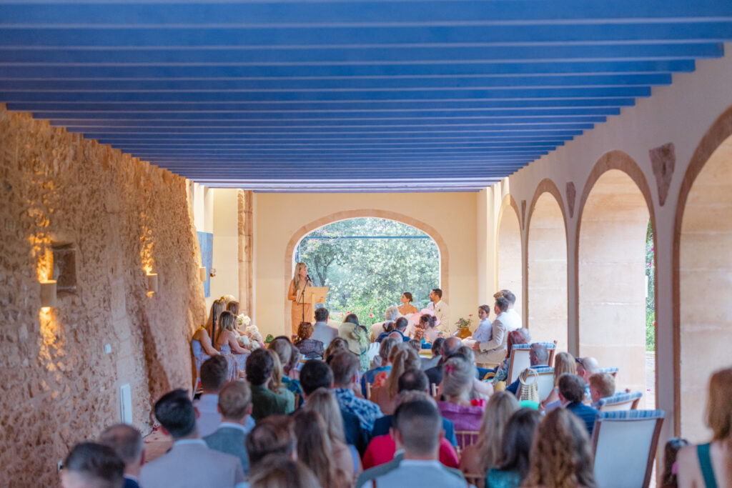 Wedding ceremony under arched porch on rainy day in Mallorca