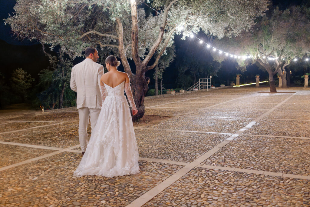 Bride and groom holding hands walking at night after rain, Son Donblon Mallorca