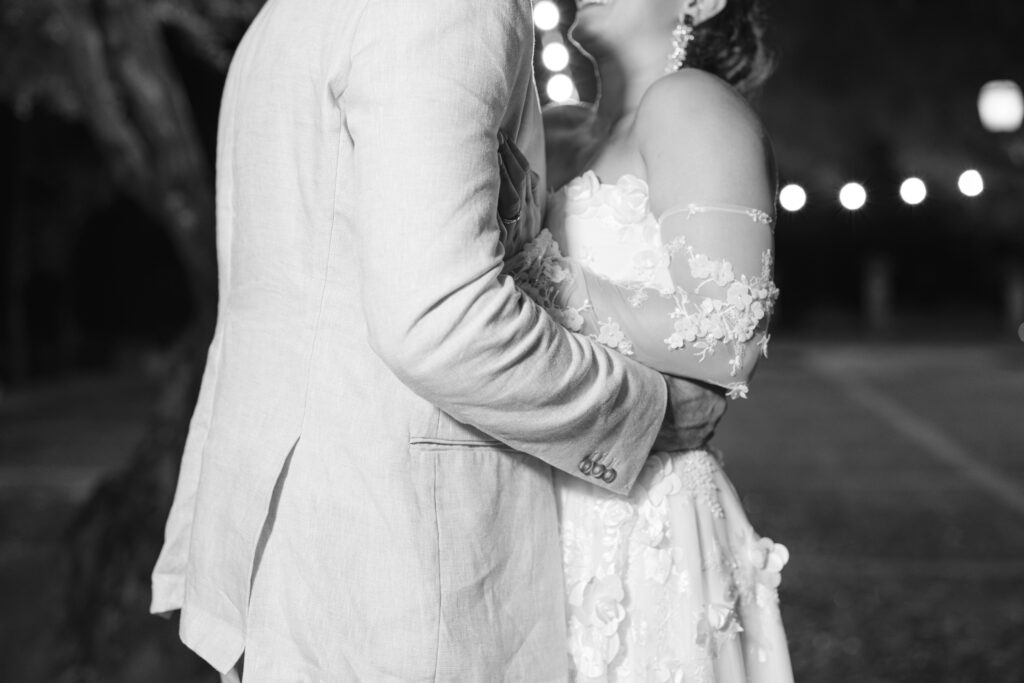 Black and white intimate portrait of bride and groom on rainy wedding night in Mallorca