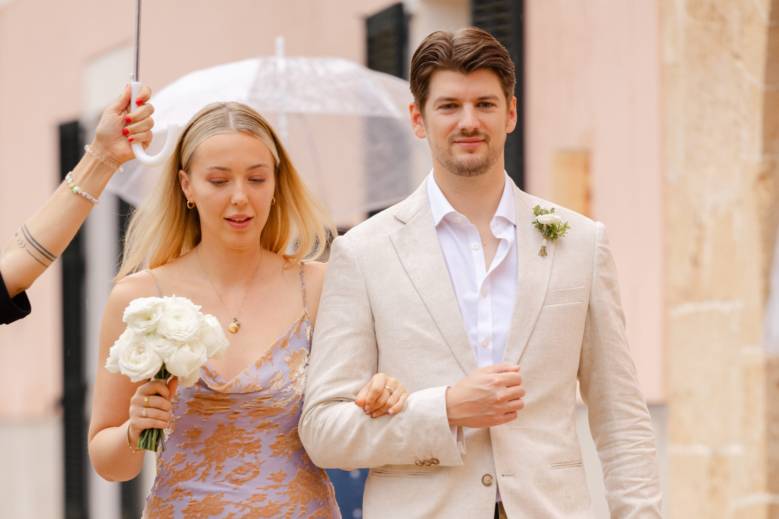 Couple with white umbrella on rainy wedding day in Mallorca