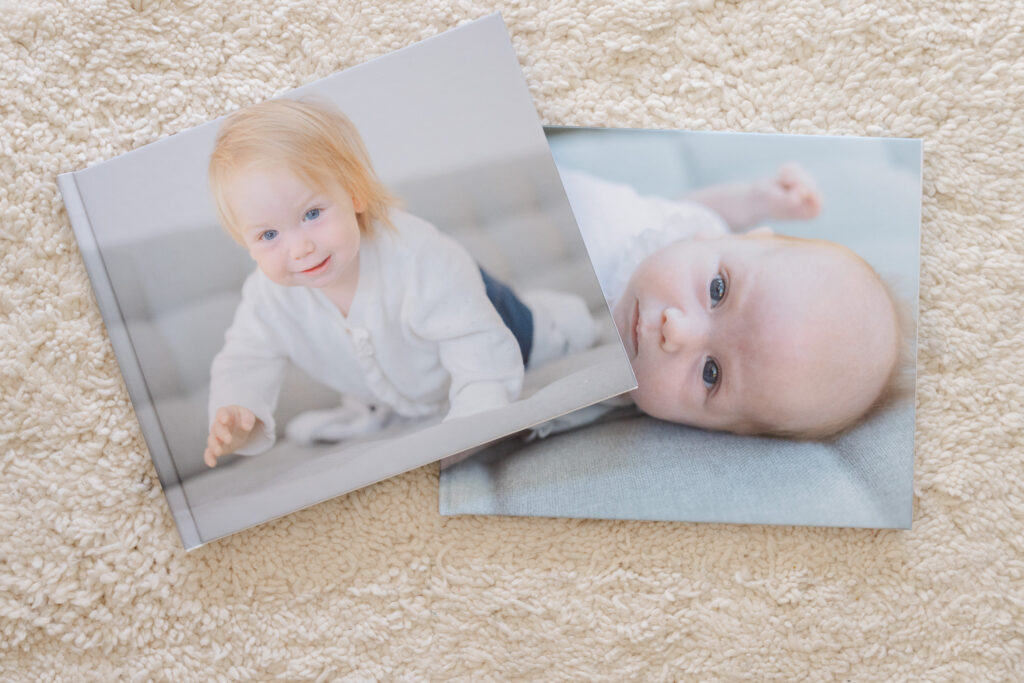 Two Floricolor baby photo albums with newborn portraits on cover, Geneva